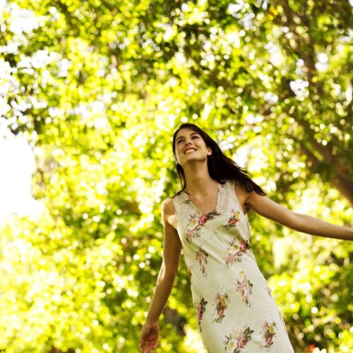 Young Woman Standing with Arms Stretched Out --- Image by © Royalty-Free/Corbis